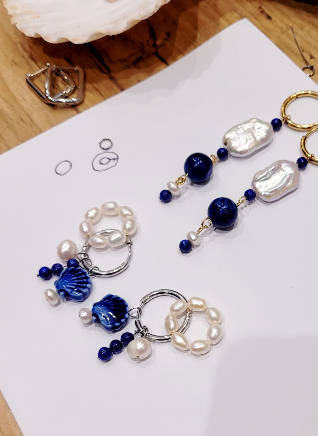 earrings with blue and white beads on a white paper background