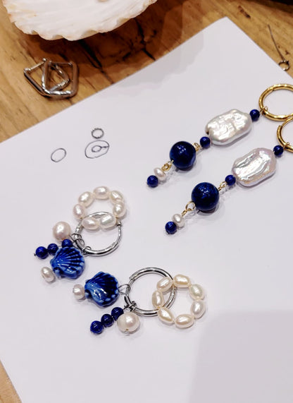 earrings with blue and white beads on a white paper background